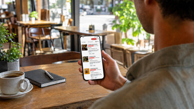 Customer comparing local business star ratings on the Yelp app before choosing where to go